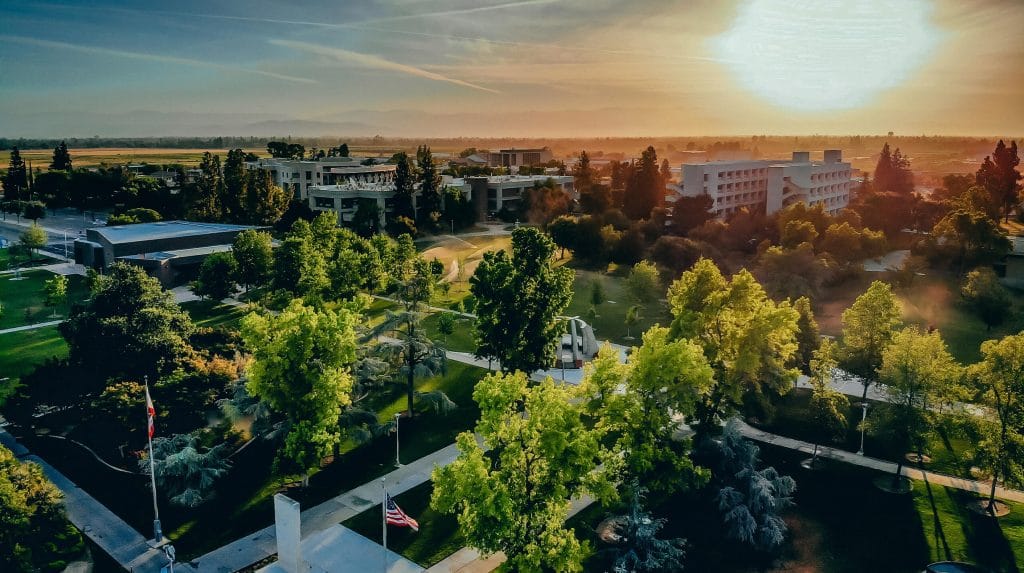 Aerial view of university campus with the sun shining in the background