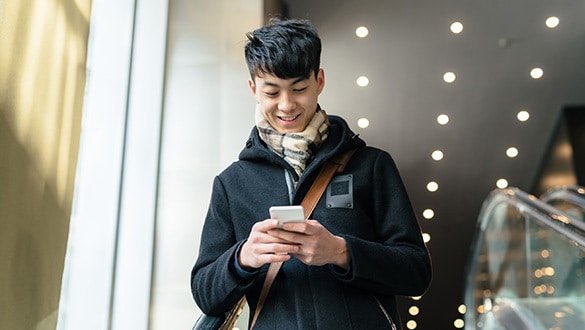 Man smiling looking at a smart phone