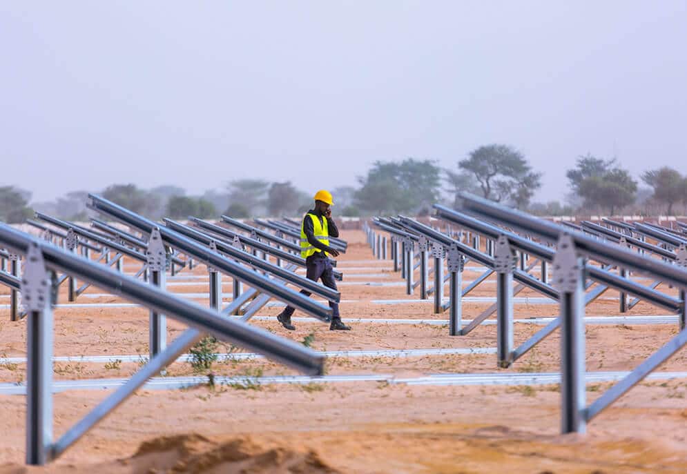 Construction worker walking through solar plant