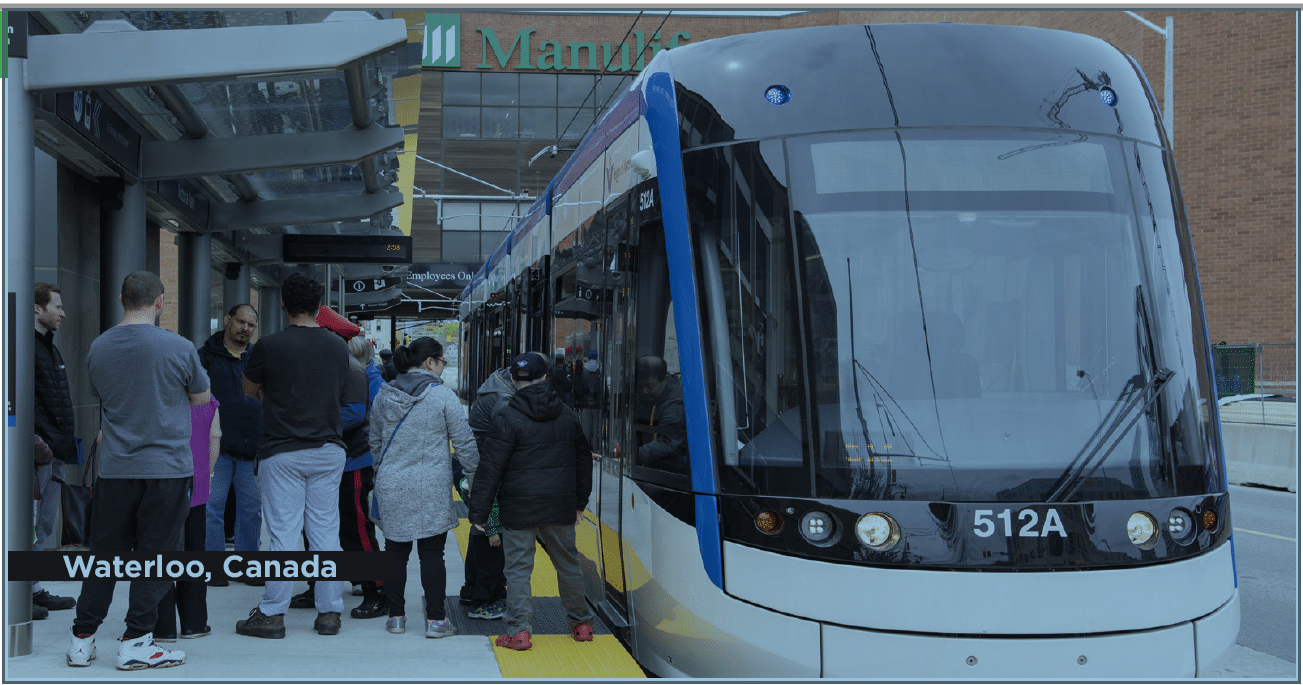 Tram at station with people waiting to get on